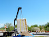 One prefabricated straw bale wall panel, ready to be placed on the foundation