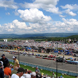 Sitting in the front stretch grandstands, looking down pit road towards turn one.