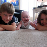 Smiling with her cousins, Liam and Clare. (July)