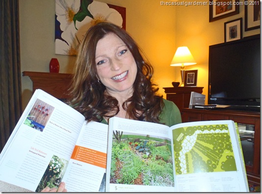 Shawna Coronado with several books her photos and garden are featured in.