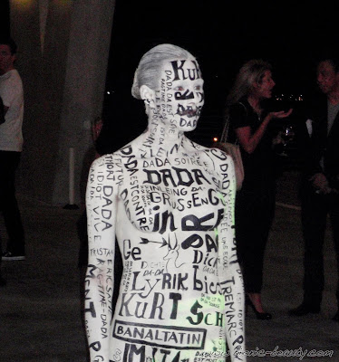 Model in white and black body paint - foreign languages and words - MAC Pro Makeup Event
