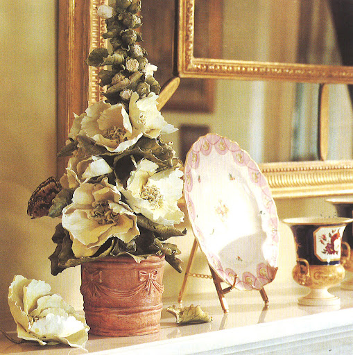 Hollyhocks made from clay atop Moss' mantle.  I also love the 19th century Derby plates.