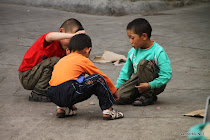 Children playing street games in the streets of Lhasa, Tibet