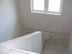Drywall over the cement in the rear stairwell