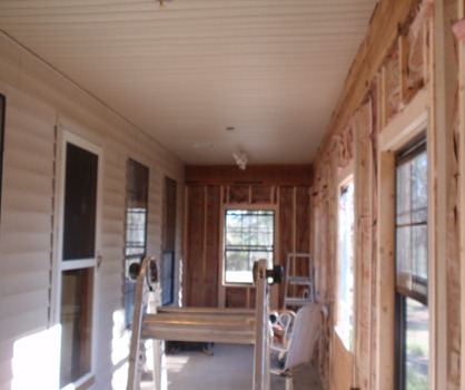 porch with clean vinyl siding roof