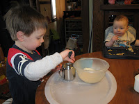Erik practices transfering by spoon and pouring