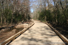 The uncompleted portion of the trail does not have grass yet and is not maintained after floods like the other sections.
