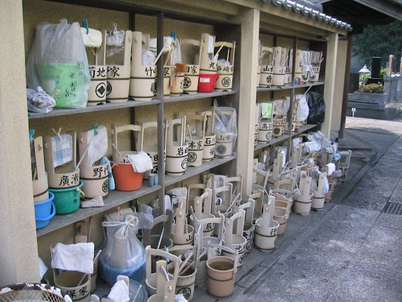 Water buckets for cleaning families' haka (family graves)