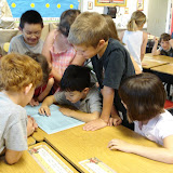 Kai and his classmates looking at the Young Authors' Project book