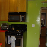 The kitchen side of the wall, with oen base cabinet and one wall cabinet already removed