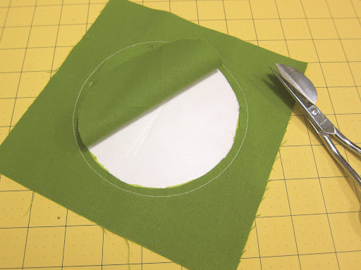 Turn over block and cut the fabric from the inside of the circle, leaving about 1/4-inch within the seam.