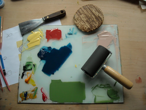 Erin uses a barren (disk in upper right-hand corner) to apply pressure to the stacked paper and ink wood block.