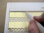 Next, I scored the paper on the gold side, every 4 loops. (With other punches, I would score in the valleys of the punch, or even just every two inches.)
