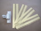 Here, all four strips have been punched along the edge and along the scored fold as described in the previous slide.