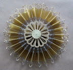 To cover the glued center of the medallion, and for some extra shimmer and fun, I added small medallions and paper dresdens to the center with hot glue. To cover the glued center of the medallion, and for some extra shimmer and fun, I added small medallions and paper dresdens to the center with hot glue.