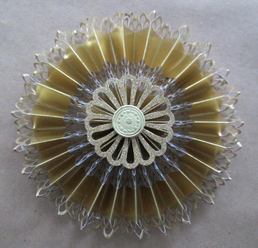 To cover the glued center of the medallion, and for some extra shimmer and fun, I added small medallions and paper dresdens to the center with hot glue. To cover the glued center of the medallion, and for some extra shimmer and fun, I added small medallions and paper dresdens to the center with hot glue.