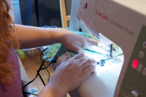 Sew straight lines across the fold to form each small pocket. This is a great time to use decorative stitches! Sew straight lines across the fold to form each small pocket. This is a great time to use decorative stitches!