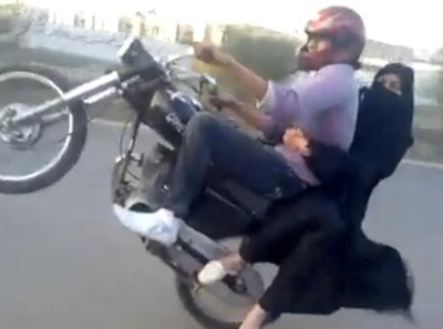Boy wheeling on Bike with his Girl Friend