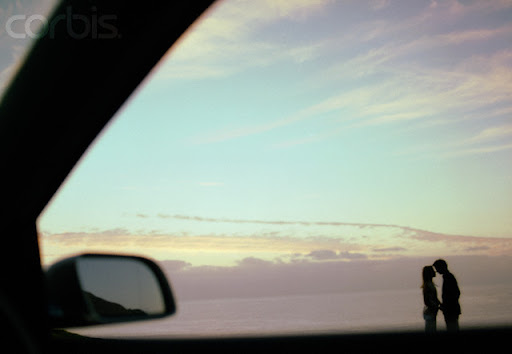 couple kissing in car. Couple Kissing by the Ocean at