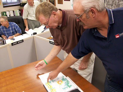 Washington County Supervisors Jim Davis (right) and Jim Rosien look over a new flood plane map at the 9/15/09 meeting (KCII NEWS)