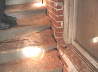 The bricks in the stairwell are soft and falling apart.  The “red dust” on the stairs is the deteriorated brick from the wall.<br />
(Washington City Hall)