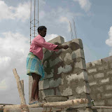 Umapati working on the wall next to the door which will come