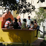 The kids scamper and find seat on graves for the drawing competition