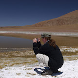 Photographer Dee crouching down in the dried Borax crystals to get her shot