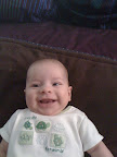 Cute baby wearing a shirt that says "Too cute for words". Truth in advertising.