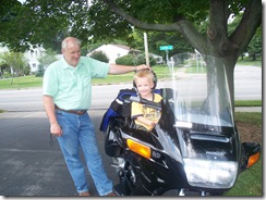 Papa John and Joshua on motorcycle Papa John and Joshua on motorcycle
