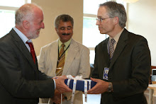Ret. Judge Carl hands over present to A/DCM Anania; middle: A/MCCA Mire