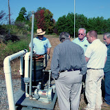 Soil Vapor Extraction System custom-built by AEM. AEM's Field Manager Eric Benton (second from right with back to camera) discusses operational issues with site owners and County maintenance crew.