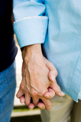 Raising community awareness for Alzheimer's disease. Holding an elderly person's hand.