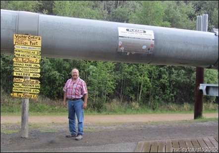 Jerry beneath the Alaska Pipeline - diameter 48 inches. Anchors 700 to 1800 ft apart hold the 420  miles of above ground pipe in place.