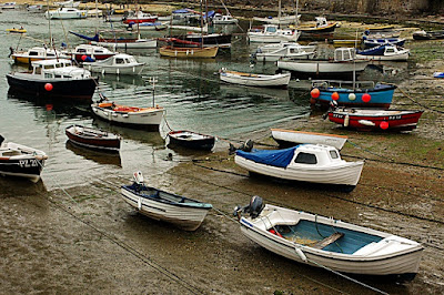The harbour at Mousehole, UK. Yes, that is the name and yes, it looks like these boats have been fished out of the sea.
