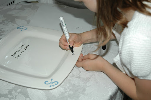 Natalie starts the signing of the guest plate