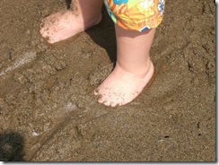 baby-feet-buried-in-the-beach-sand