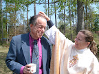 Mitzi George crushes a confetti egg over Reed Mendelson, Easter, 2008.