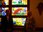 Bill and Anita Luff next to the stained glass window of The Crucifixion