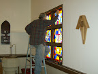Frank Thompson installing the east side stained glass windows.