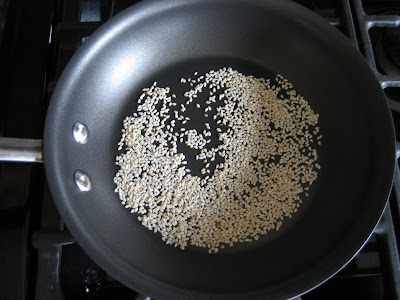 Toasting sesame seeds for the cucumber radish salad