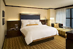 Minimalist style translates into maximum New York City comfort. Local walnut wood furniture is accented by gold and blue and our signature luxurious bedding. Double-paned windows ensure a peaceful night's sleep. www.NYCRenaissance.com