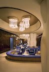 The main lobby of our Times Square hotel sets the tone for urbane sophistication. Handmade chairs in blue are set against acid washed copper walls. www.NYCRenaissance.com