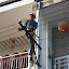 A local workman carefully rewiring the entire district in a single afternoon.