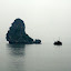 Another junk silhouetted against the grey sky...
