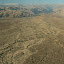 Where the arid desert meets the mountains, but in these dried out deltas there is vegetation that hints at wetter seasons.