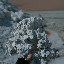 A chunk of borax, hopefully not corrosive to human touch.