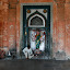 At one end of the square stands the temple, and a bell for praying.