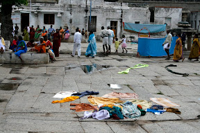 Inside the first walls of the temple, many locals simply hang around, drying clothes, chatting, and hawking tourists.