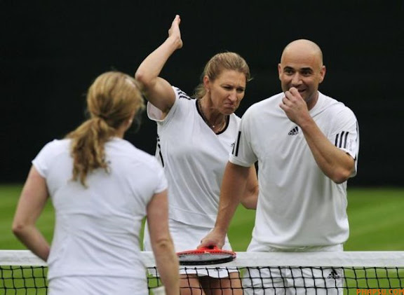 RNPS IMAGES OF THE YEAR 2009 - Germany's Steffi Graf (L) reacts after Andre Agassi of the U.S. accidentally hit Belgium's Kim Clijsters (C) with the ball during their mixed doubles match under the newly completed Centre Court roof at Wimbledon in London May 17, 2009.     REUTERS/Kieran Doherty     (BRITAIN SPORT TENNIS IMAGES OF THE DAY)